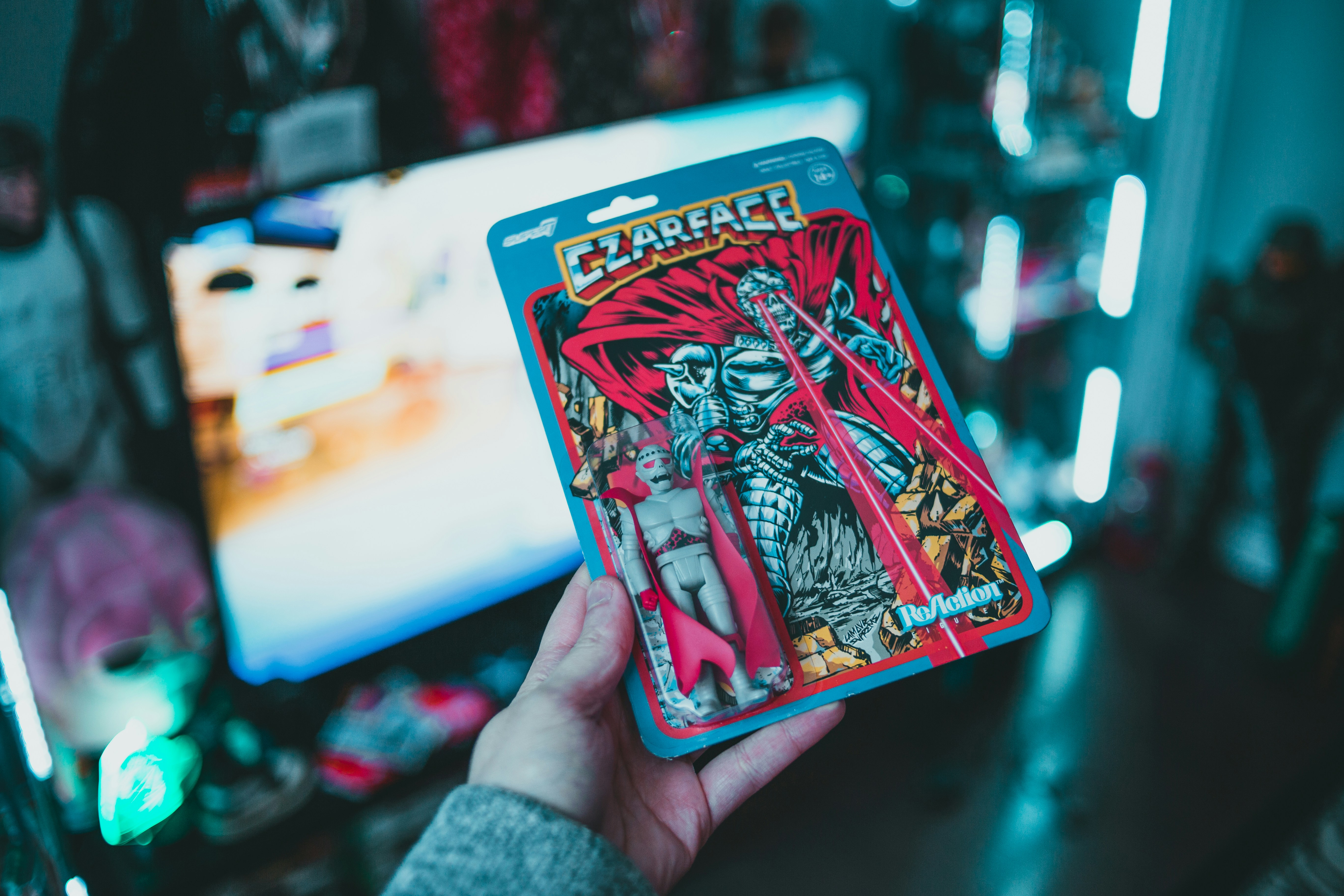 person holding red and white playing card
