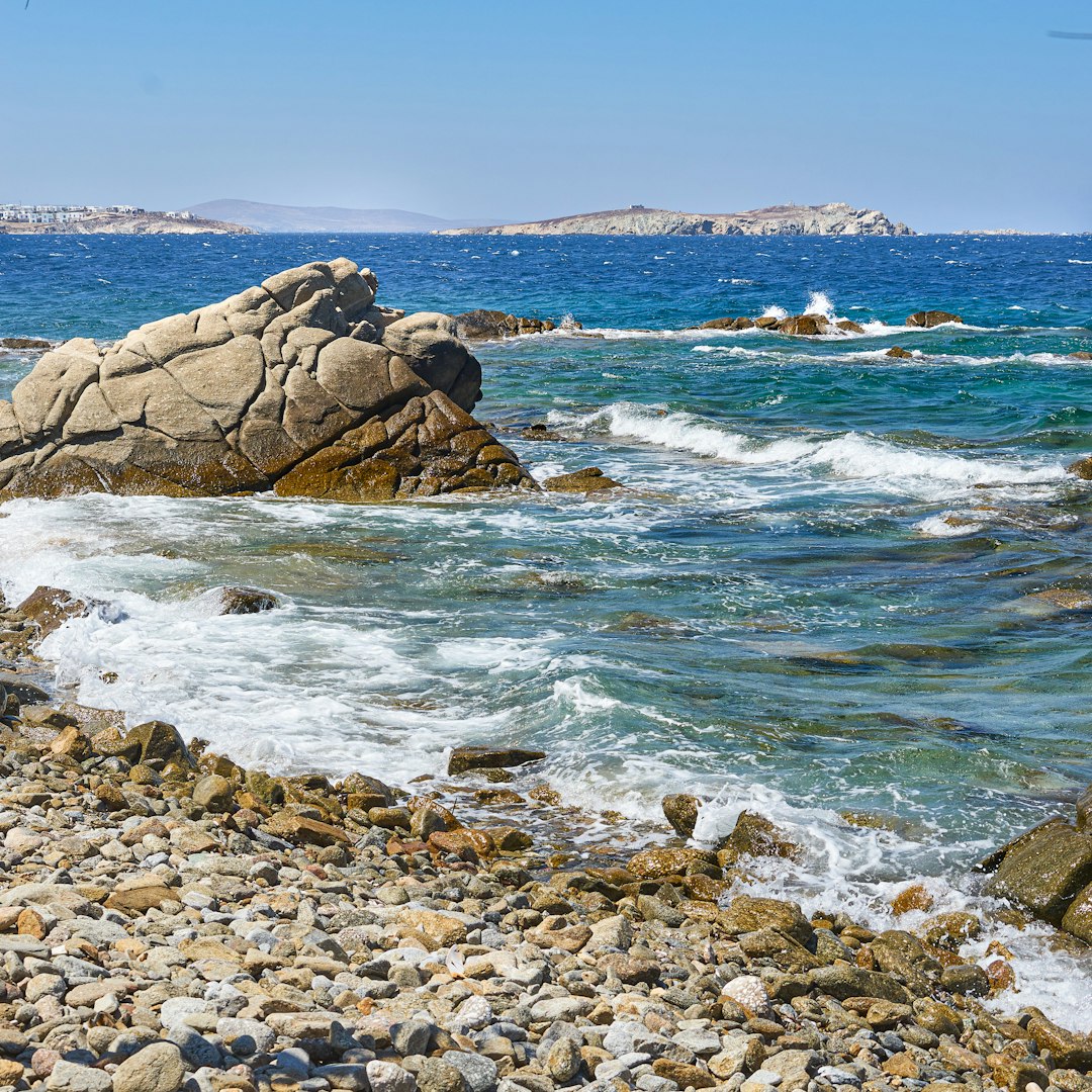 brown rock formation on sea during daytime