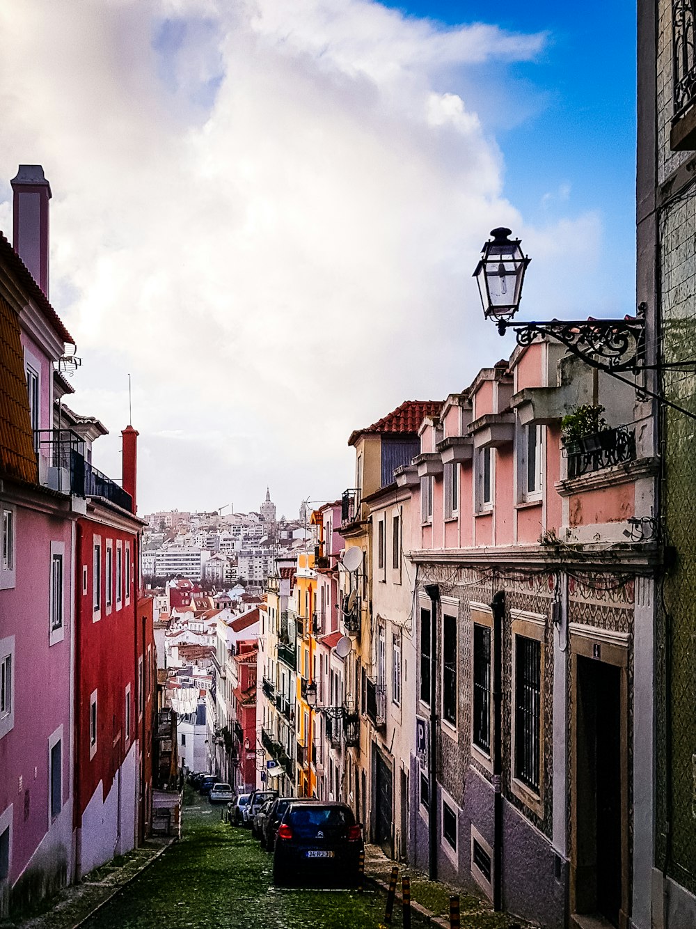 red and white concrete buildings under white clouds during daytime