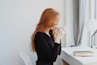 woman in black long sleeve shirt sitting on chair