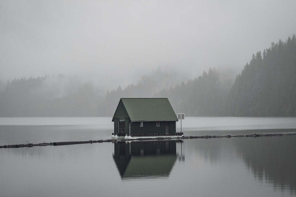 gray wooden house on body of water