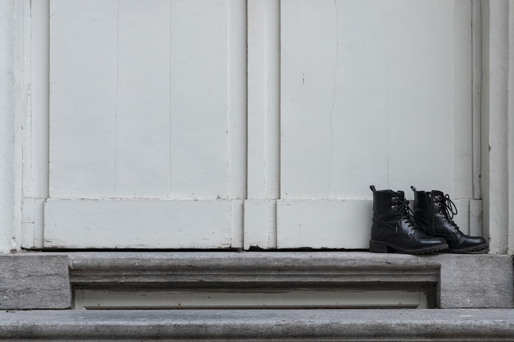 black cat on white wooden window