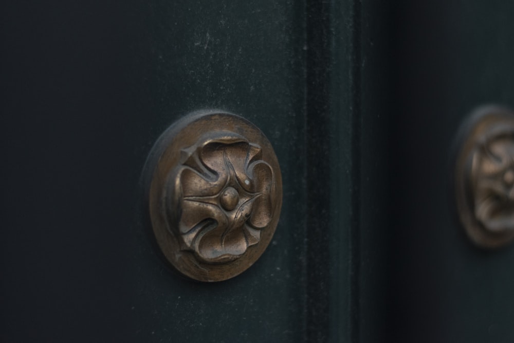 a close up of a door handle on a black door