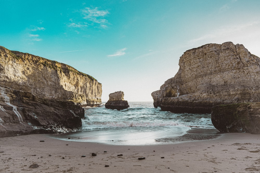 brown rock formation on sea shore during daytime