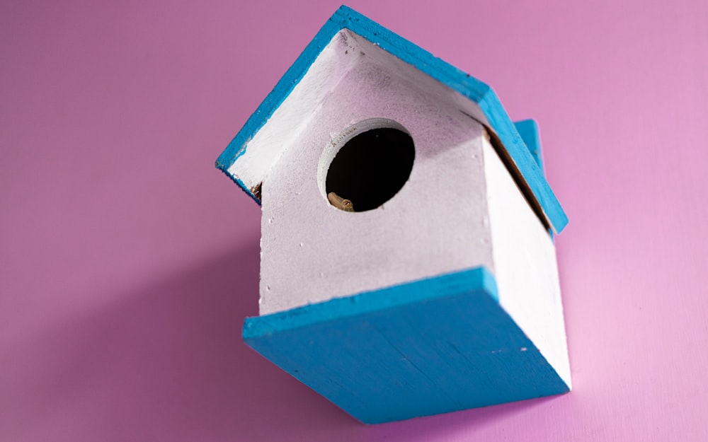 blue and orange wooden bird house