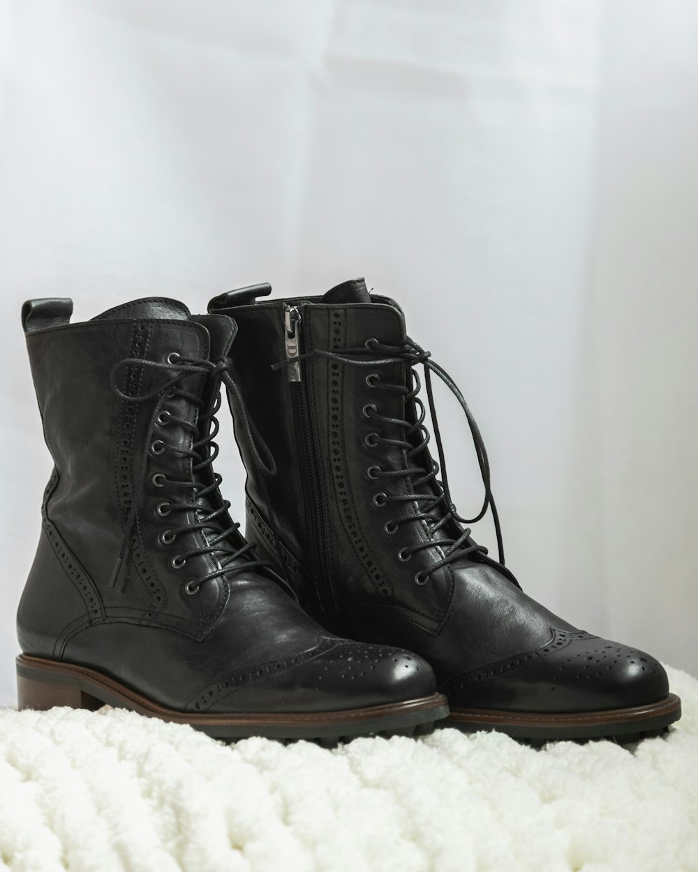 Botas de cuero negras sobre textil blanco