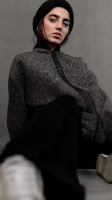A casual outfit featuring a man in a stylish gray hoodie and jeans.