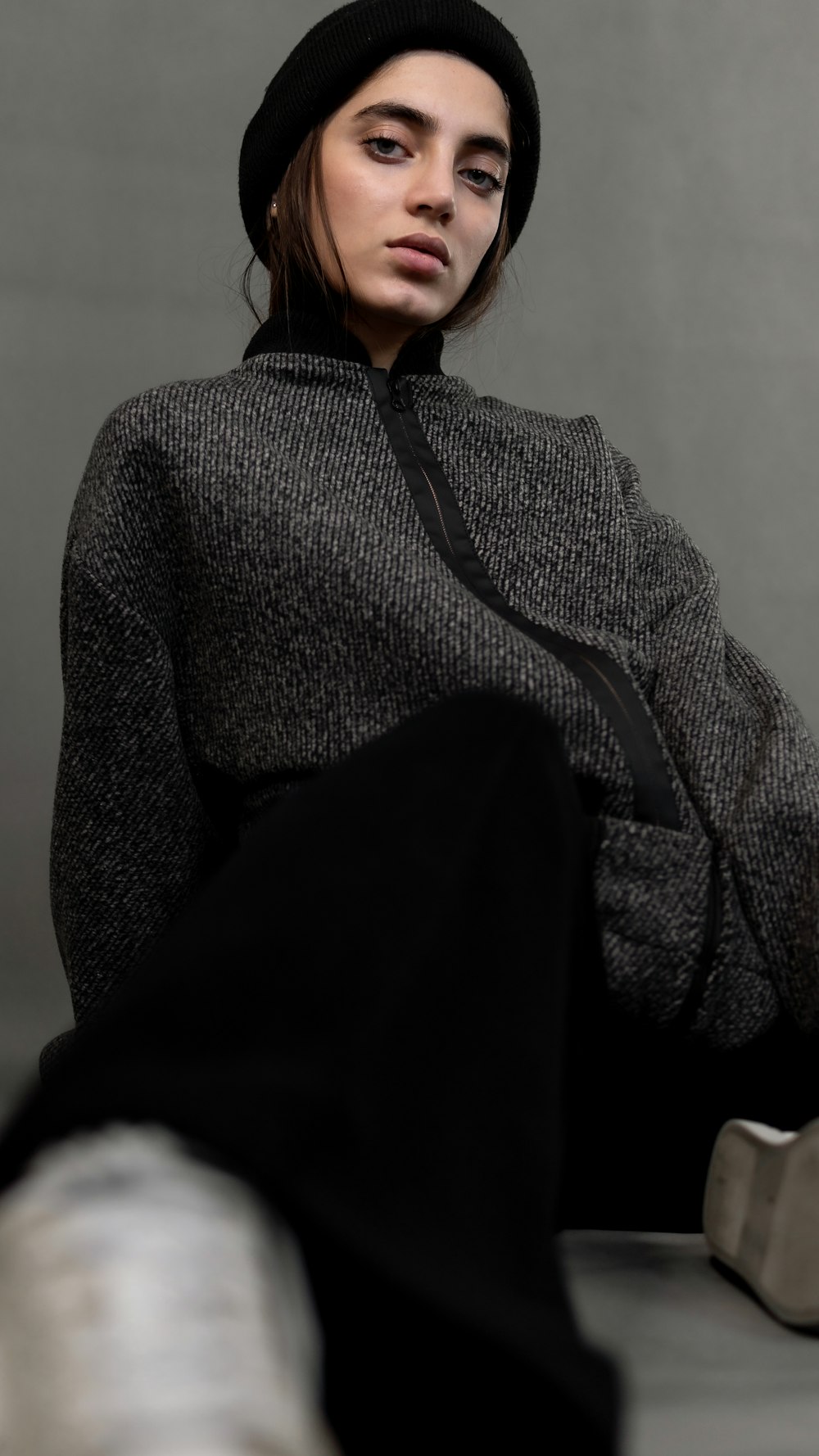 woman in gray sweater sitting on chair