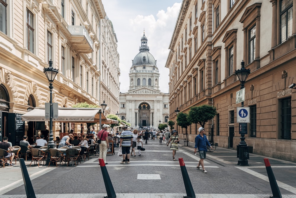 people walking on street near brown concrete building during daytime