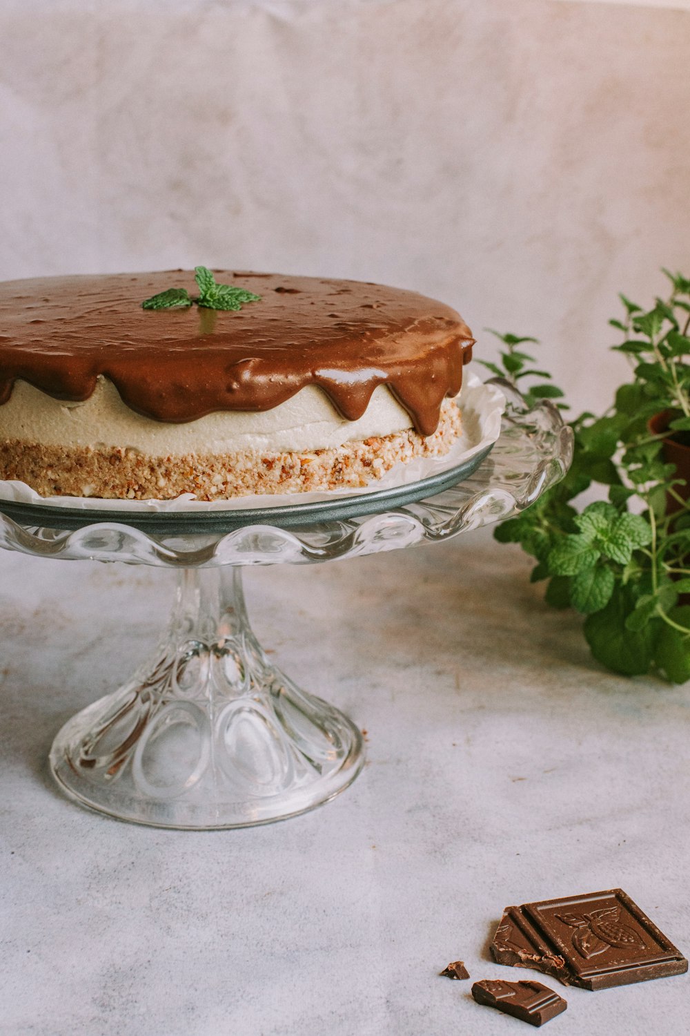 brown and white cake on clear glass cake stand