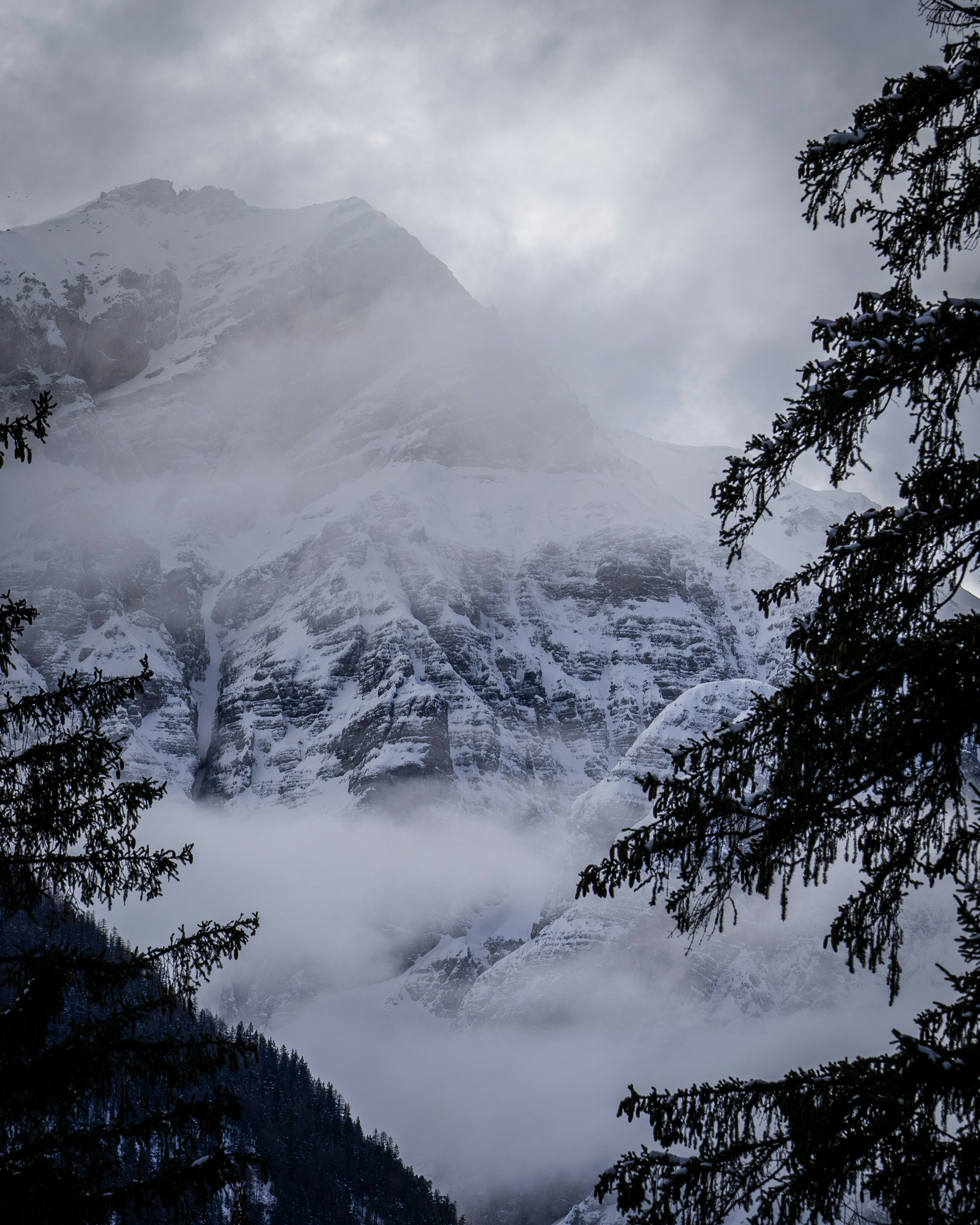 snow covered mountain under cloudy sky during daytime