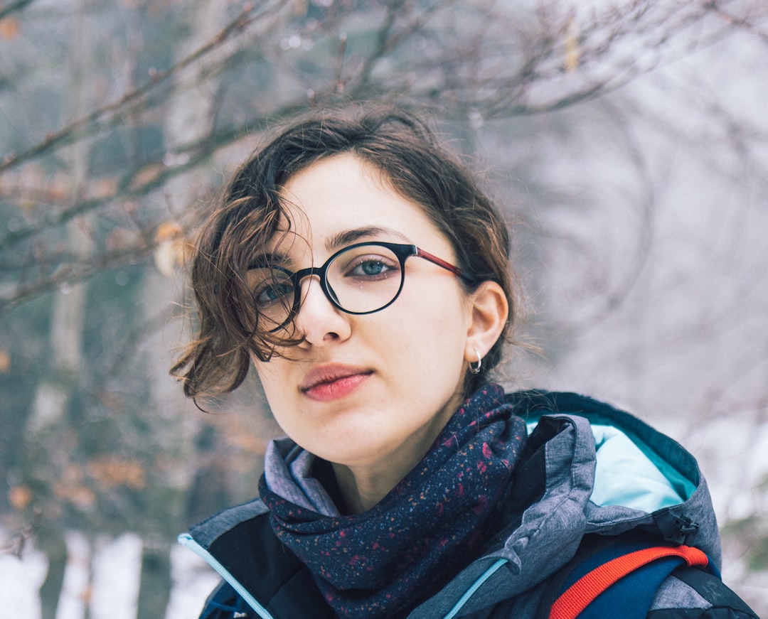 girl in black framed eyeglasses and black jacket