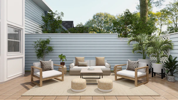A stylish outdoor patio set made from weather-resistant teak wood surrounded by lush greenery.
