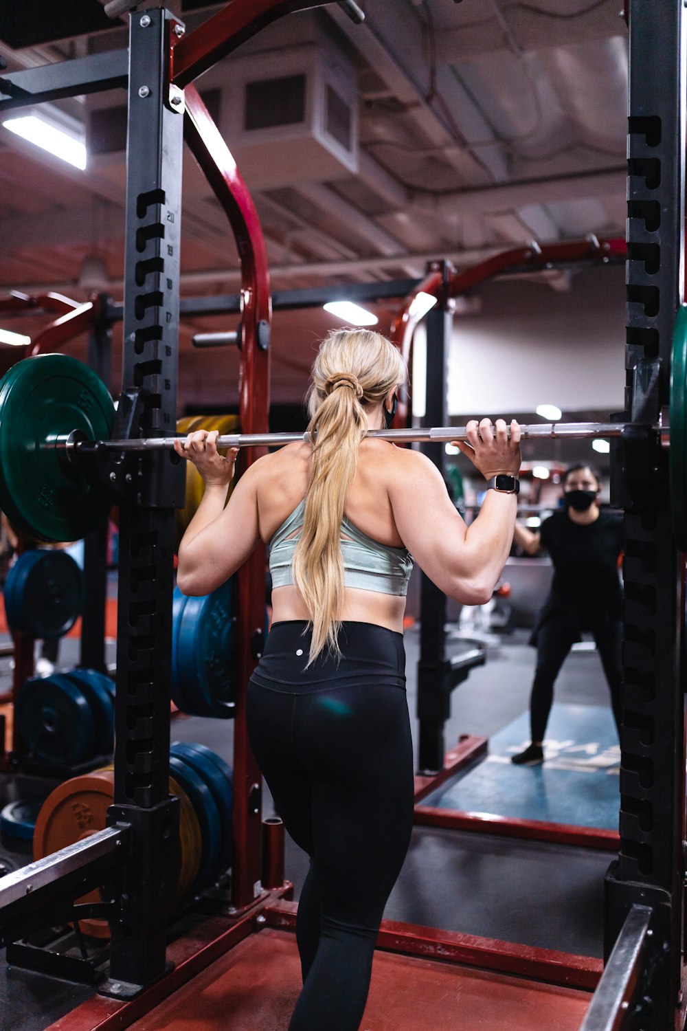 woman in black tank top and black leggings doing exercise