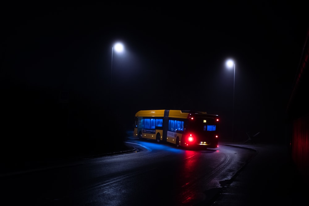 red bus on road during nighttime