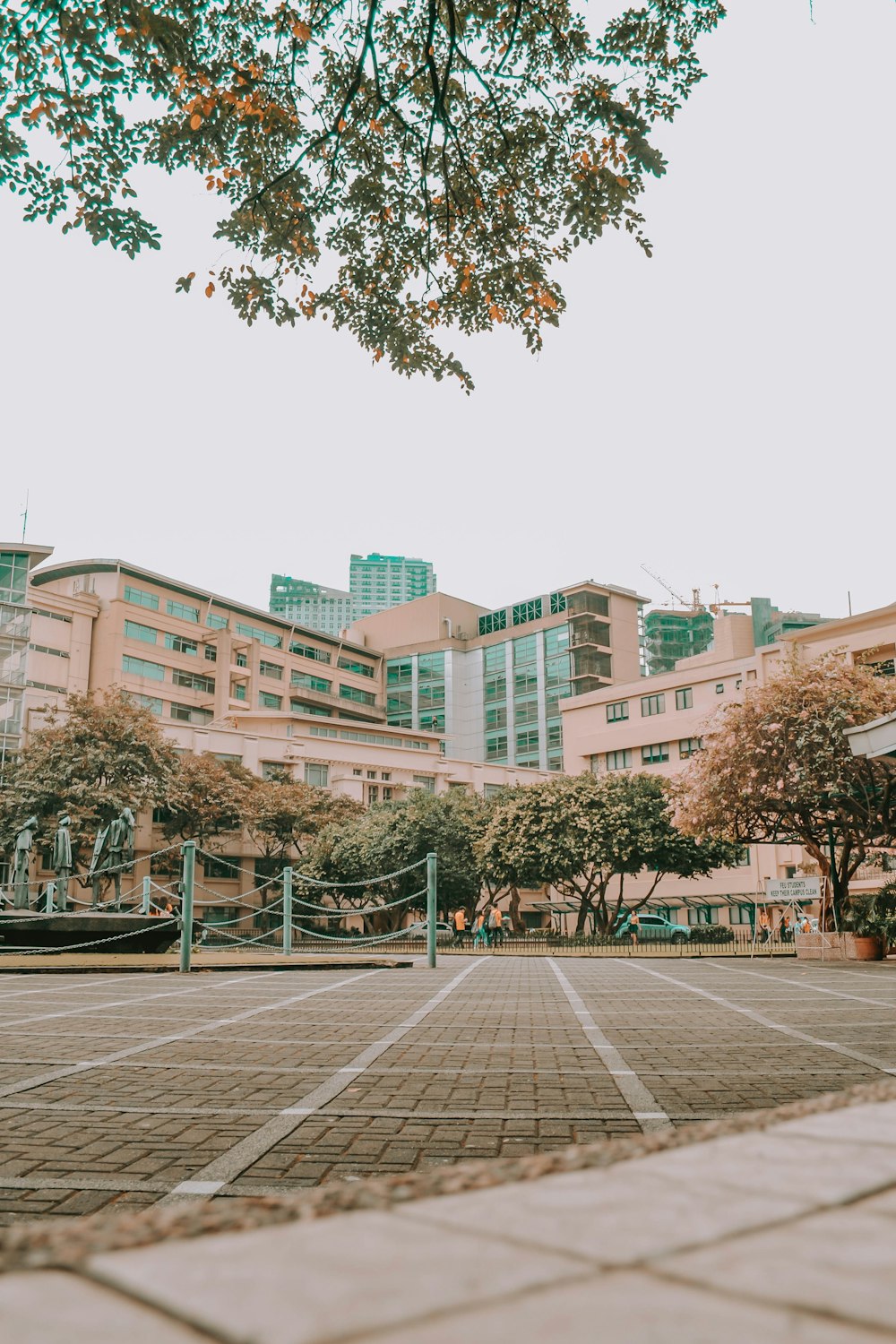 brown and white concrete building near green trees during daytime