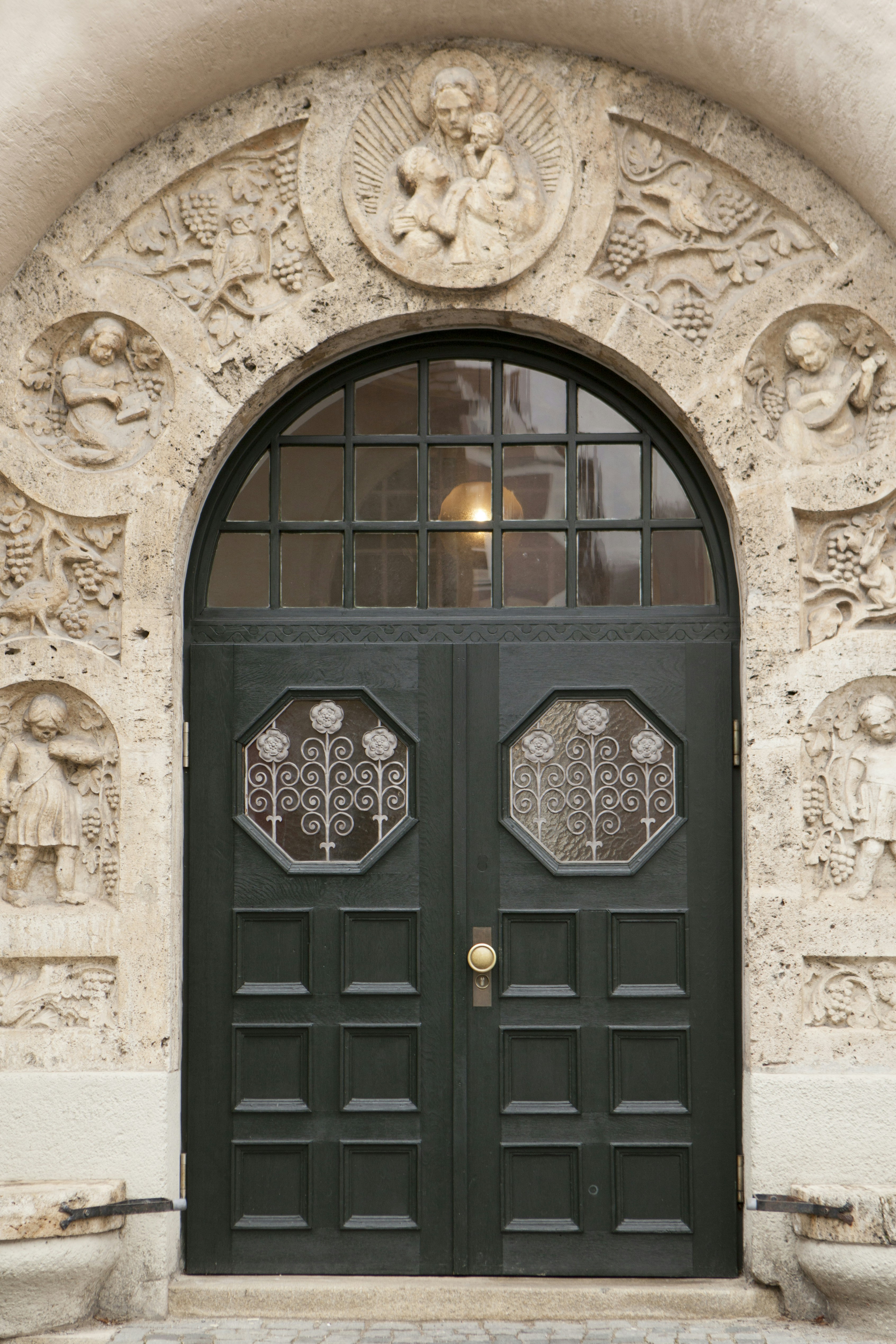 black wooden door with brown concrete wall