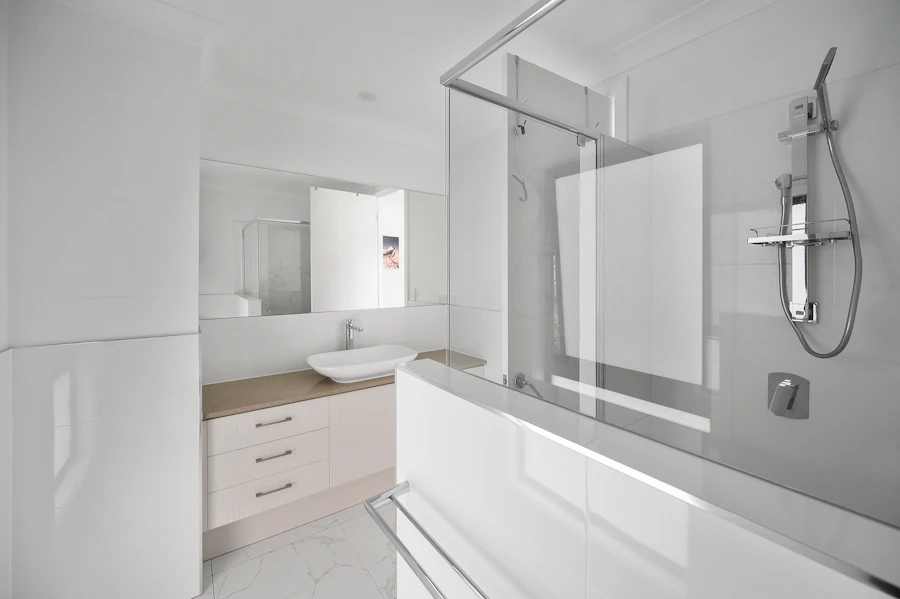 Custom white wood bathroom vanity cabinet with mirror