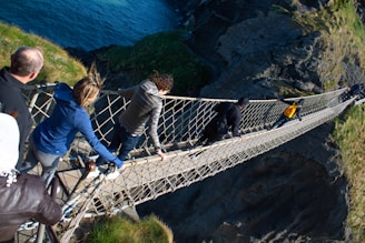 Participants crossing a rope bridge during an outdoor team challenge event