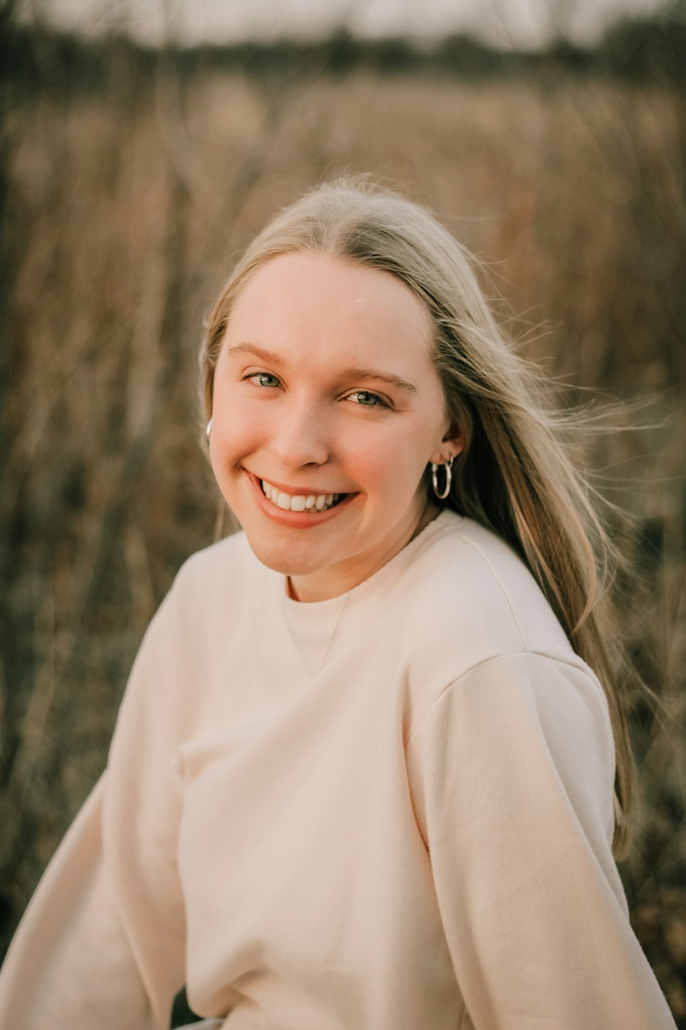 smiling woman in white turtleneck long sleeve shirt