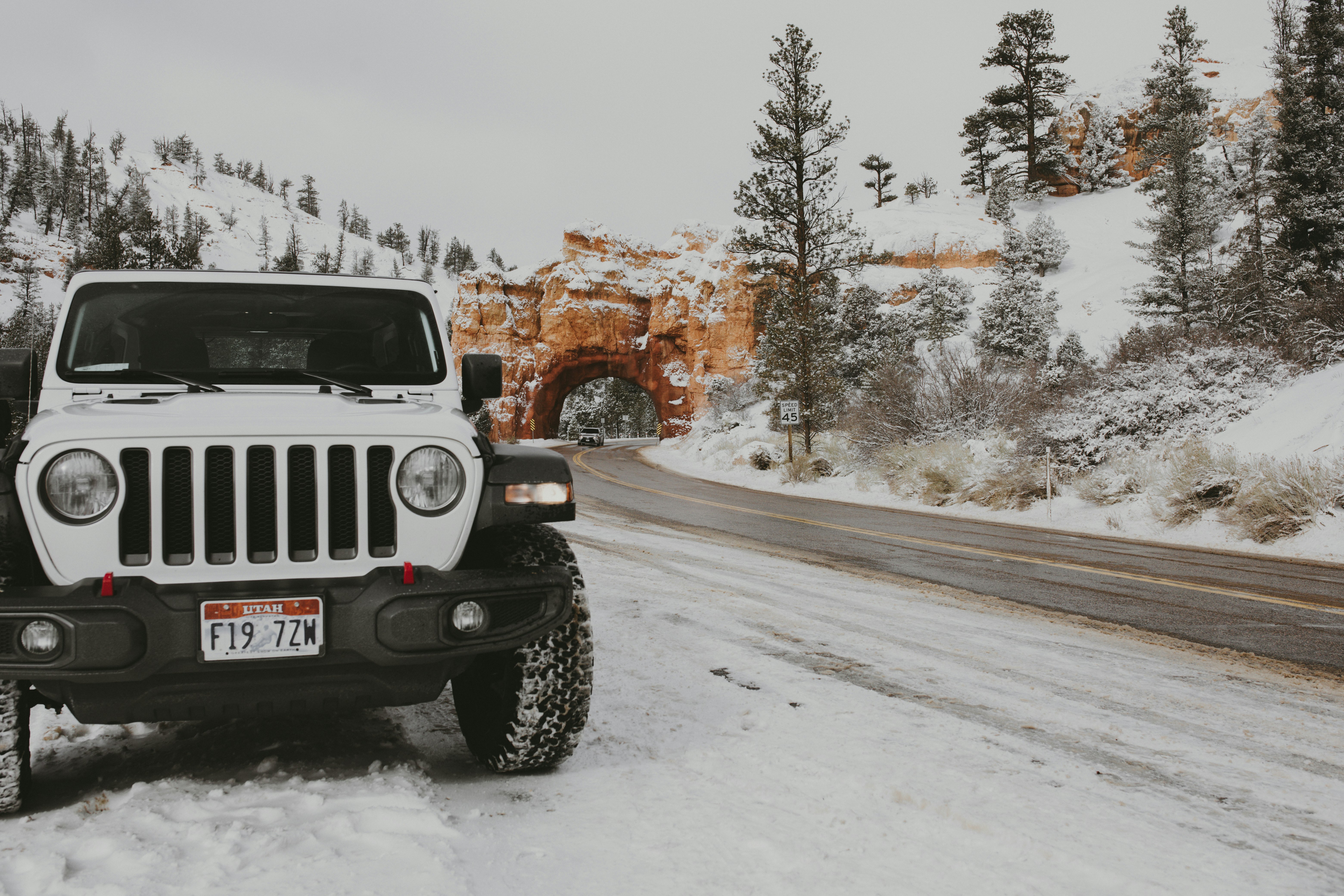 white jeep wrangler on road during daytime