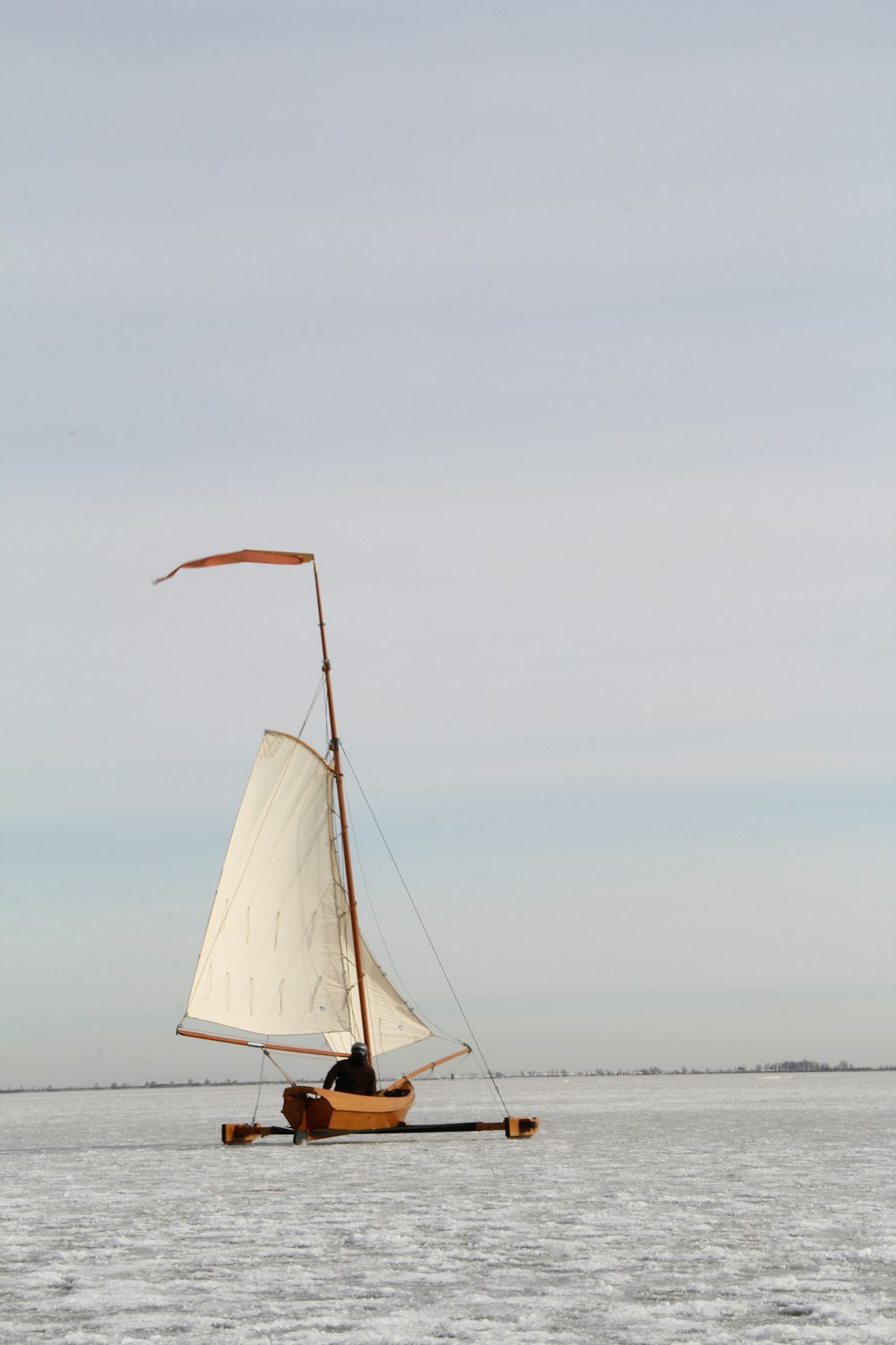 white sail boat on sea during daytime