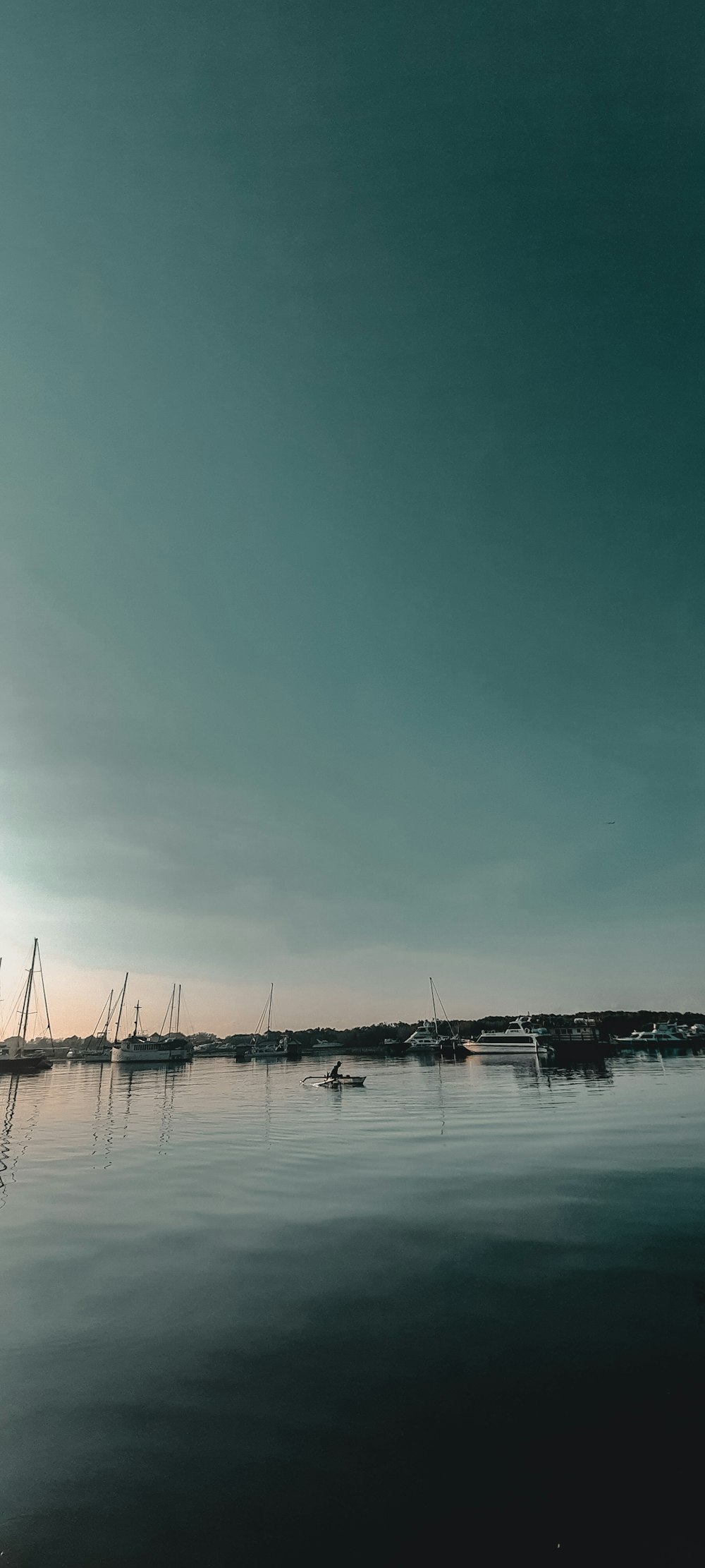 white sail boat on sea under blue sky during daytime