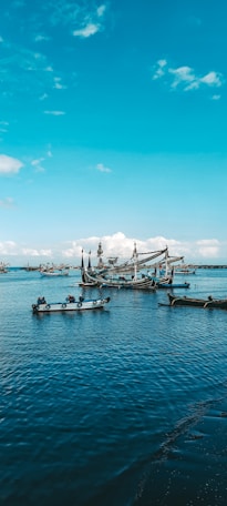white and blue boat on sea during daytime