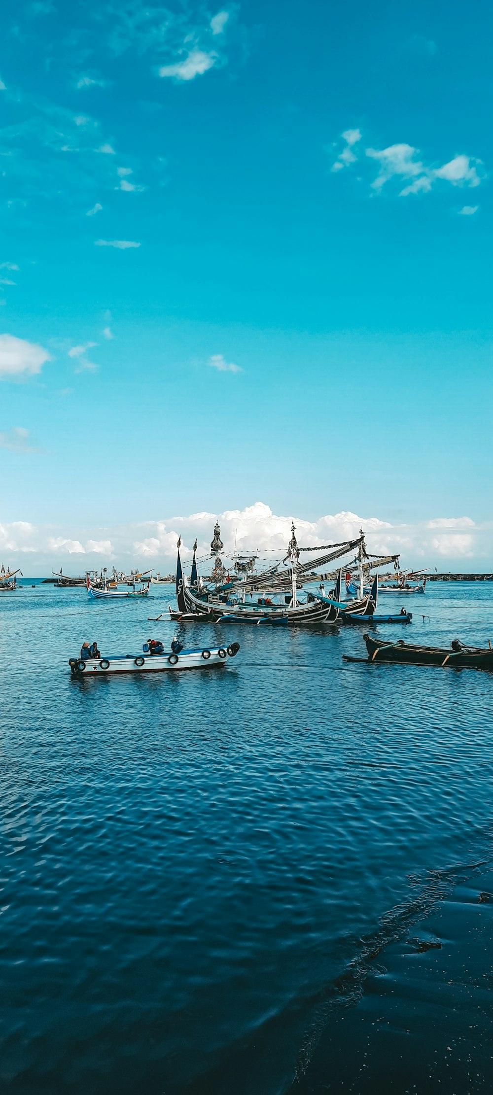 white and blue boat on sea during daytime