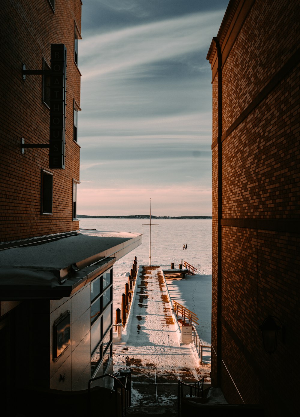 brown brick building near body of water during daytime