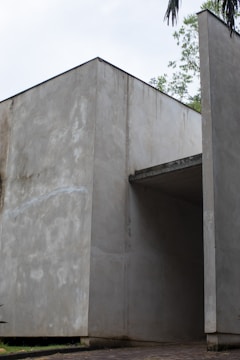An agricultural structure with strong concrete foundations and open, airy design.