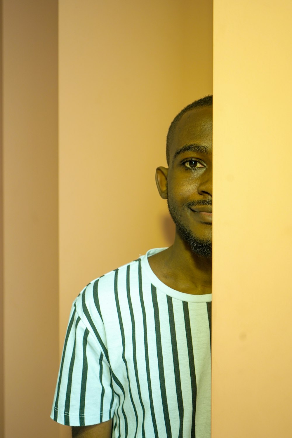 man in white and blue striped crew neck shirt