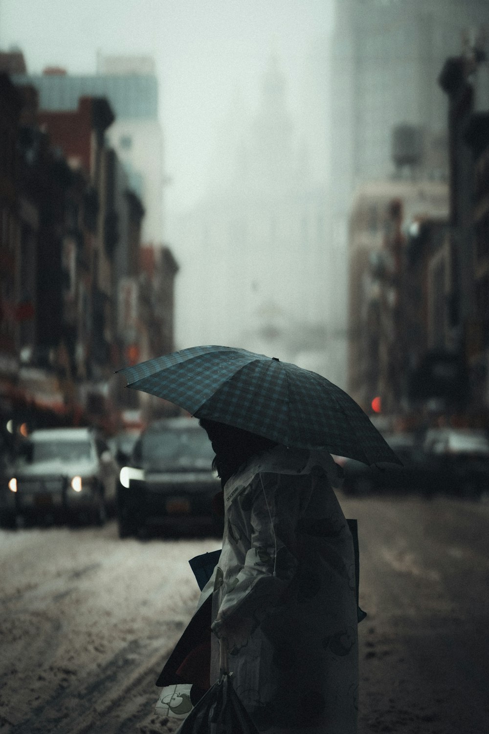 person in black jacket holding umbrella