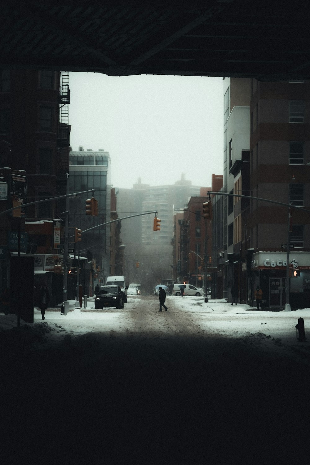 person in black jacket walking on street during daytime