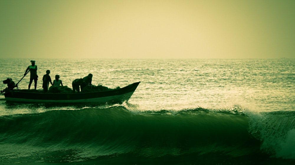 2 people riding on red boat on sea during daytime