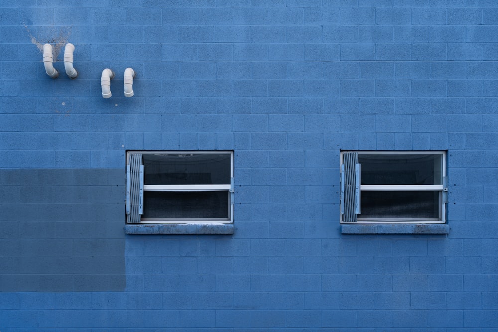 blue concrete building with white framed glass window