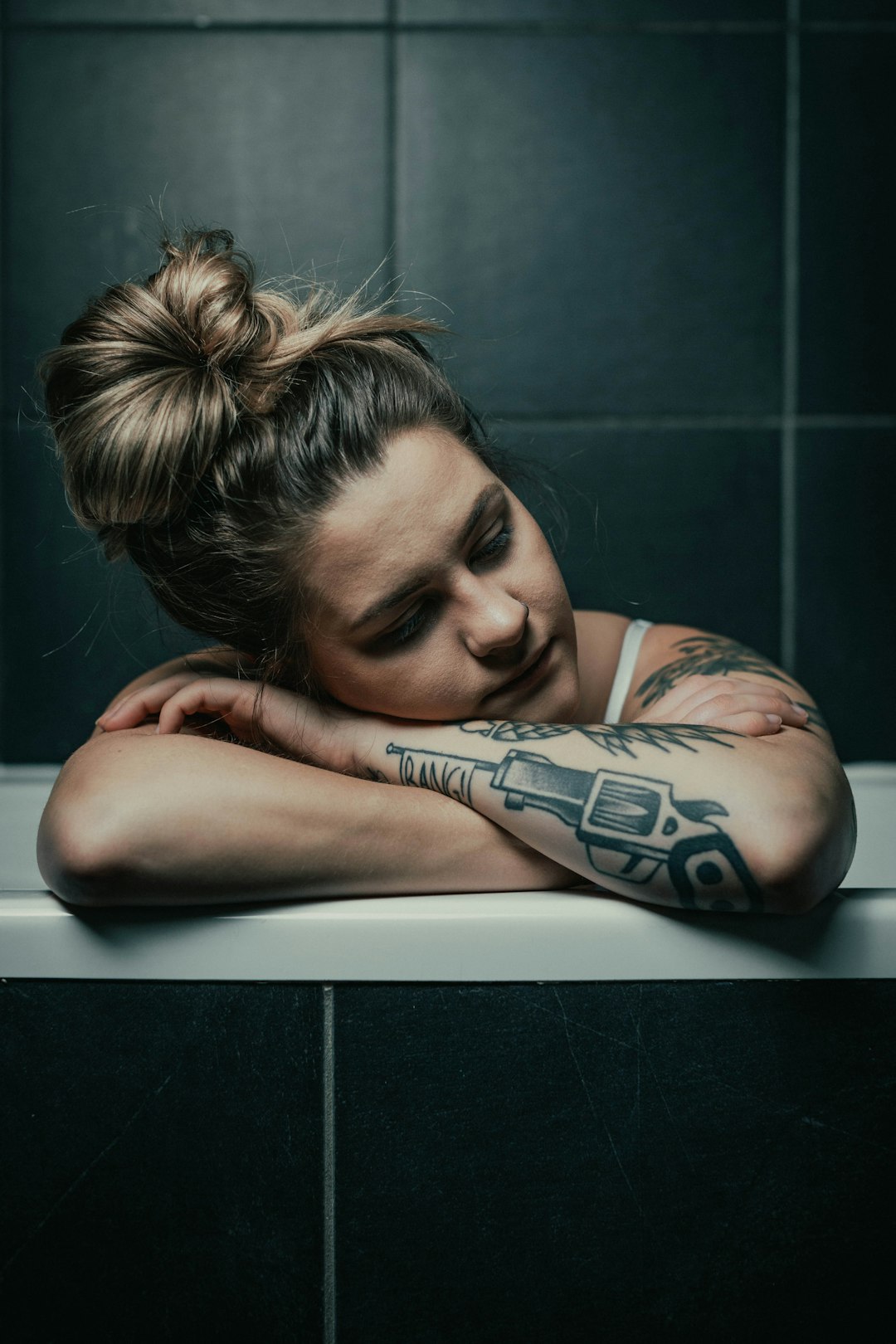 woman in blue and white floral dress lying on white ceramic bathtub