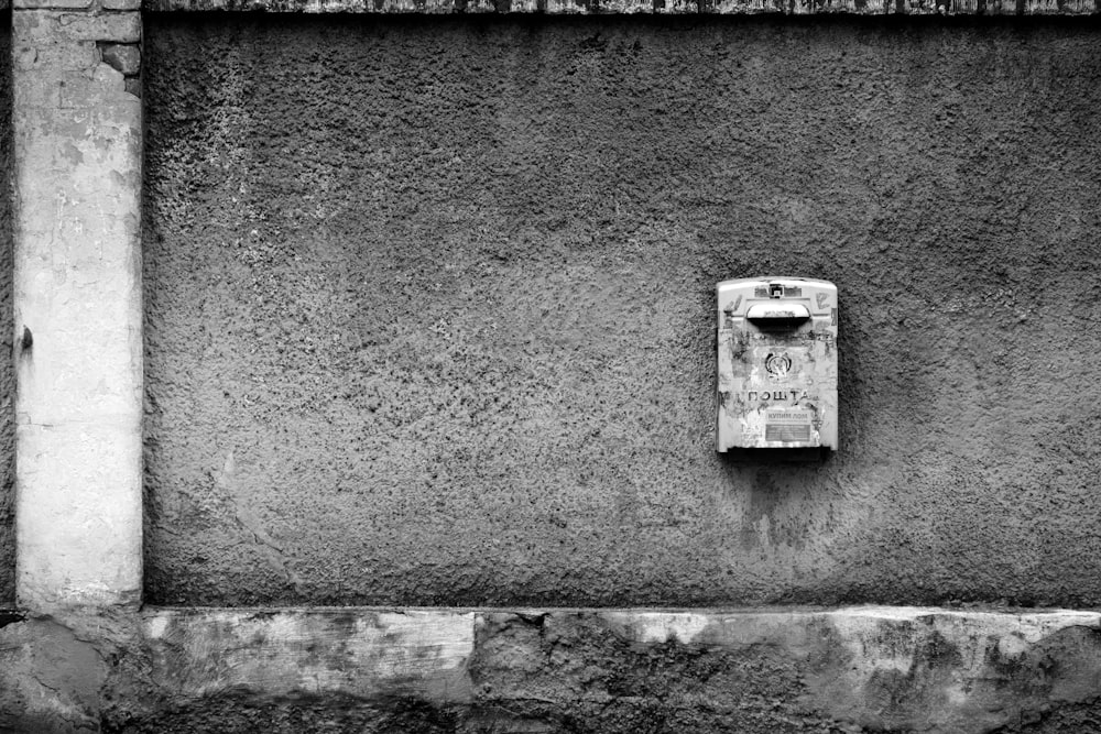 grayscale photo of a wall mounted device