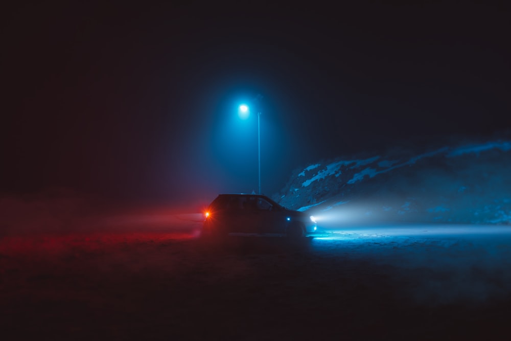 black car on road during night time