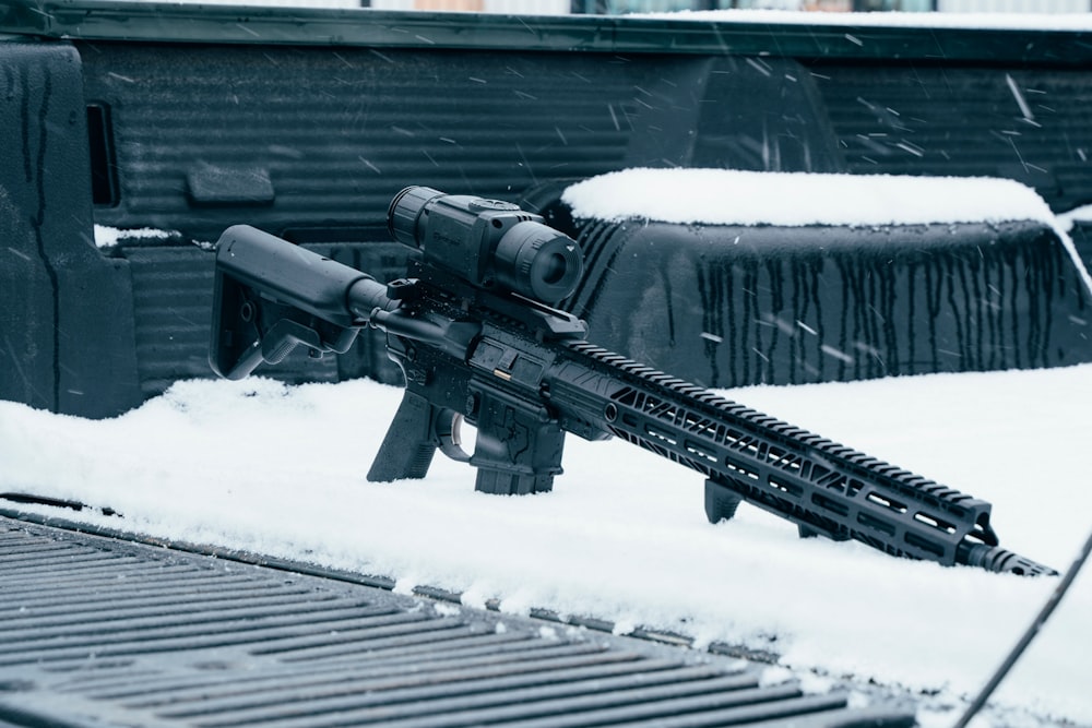 black rifle on snow covered ground