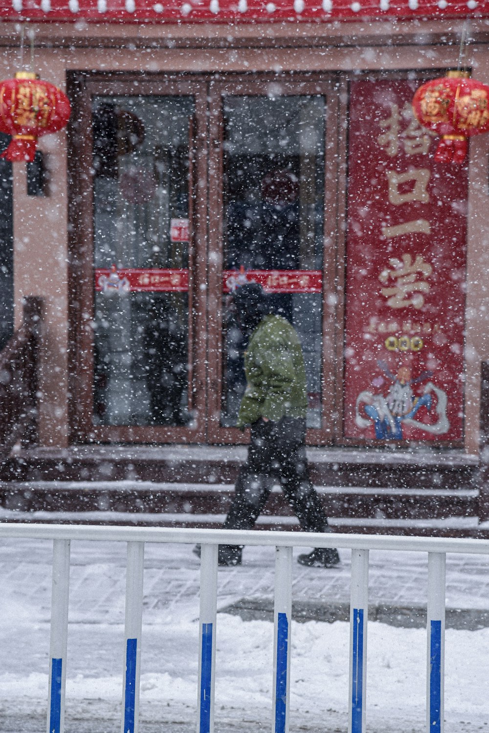 person in black jacket standing on white snow covered ground