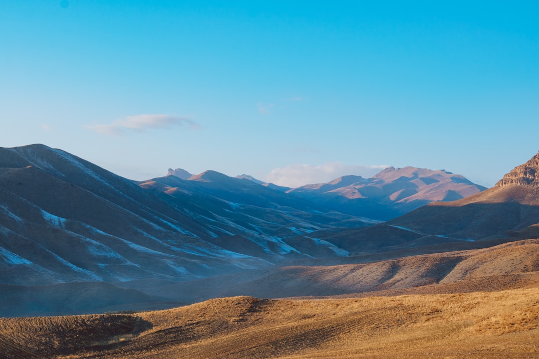 green and brown mountains under blue sky during daytime