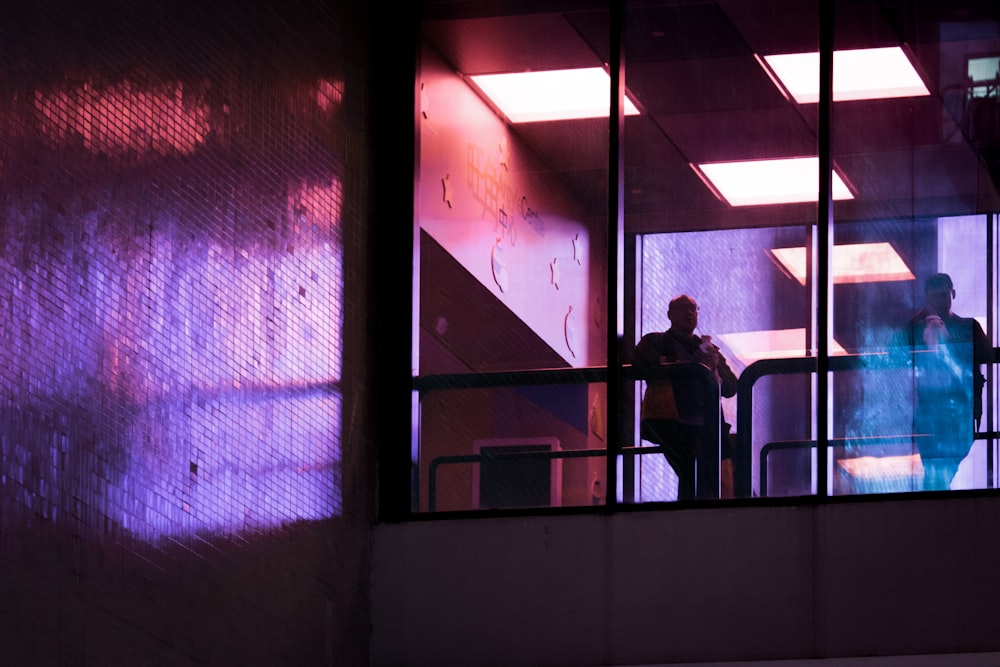 silhouette of man standing near window