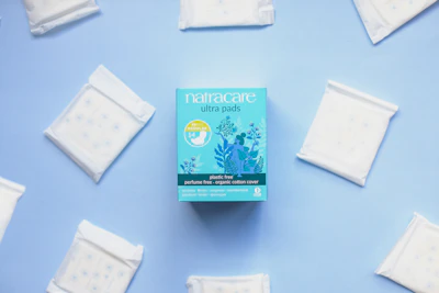 Close-up of a soft, breathable sanitary pad with an anion strip glowing faintly pink