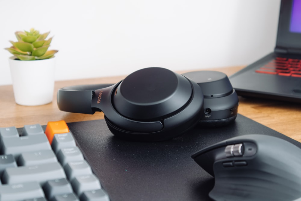 black headphones on black computer keyboard