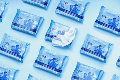 Close-up of gentle baby wipes being pulled from a personalized packaging with pastel colors.