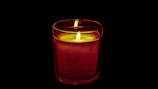Glass candle urn hang hardware holding a softly glowing candle, creating a cozy ambiance.
