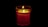 A happy customer holding a glowing LED candle in a cozy setting.