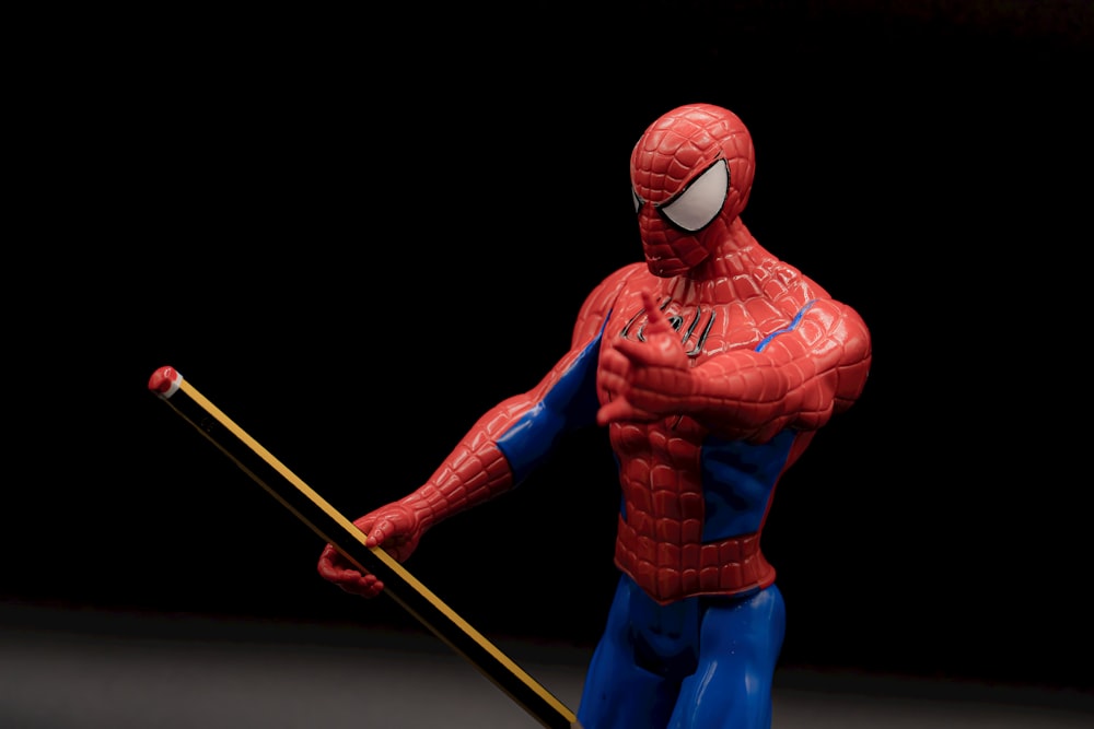 spider man holding yellow stick