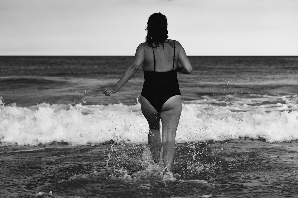 woman in black bikini standing on beach